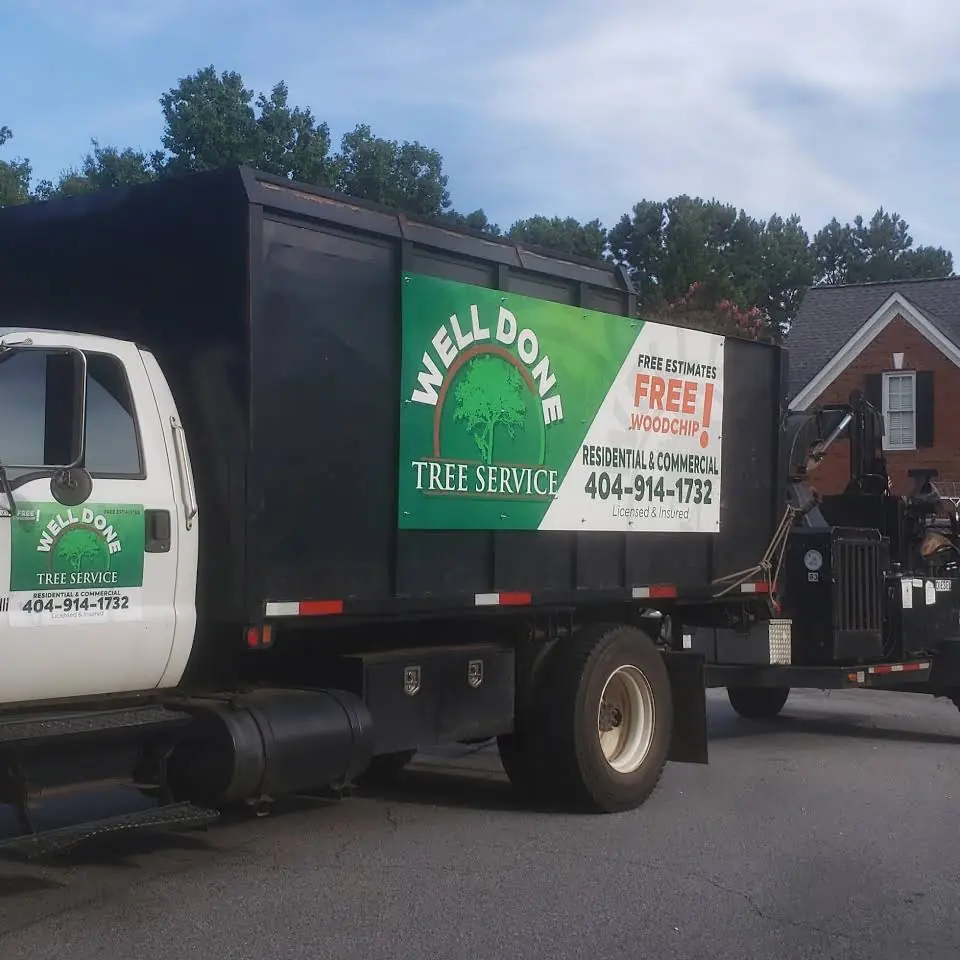 Well Done Tree Service chip truck and chipper parked outside a Georgia home before a removal